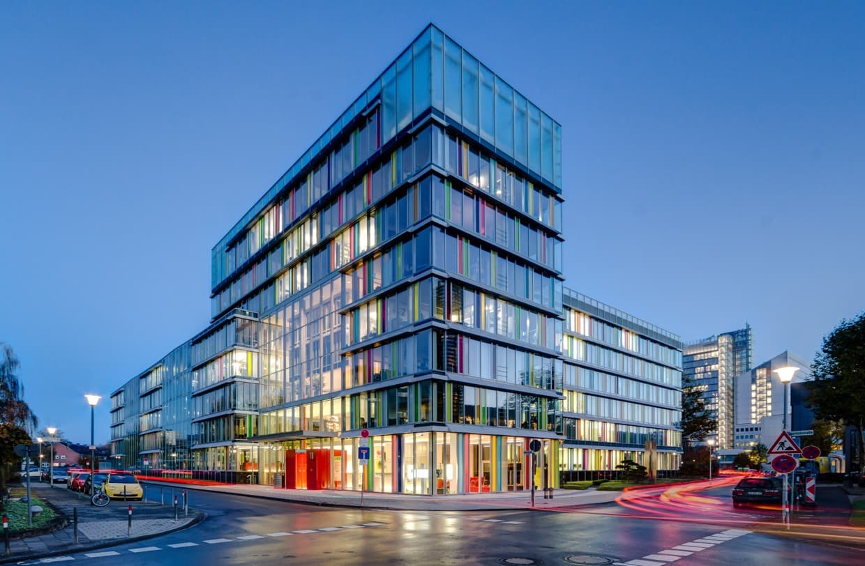 Glass-fronted contemporary office building at dusk